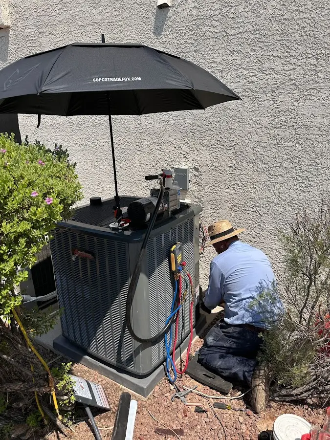 HVAC technician performing outdoor AC maintenance in Nebraska City